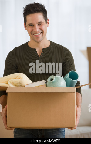 Man carrying moving box Stock Photo