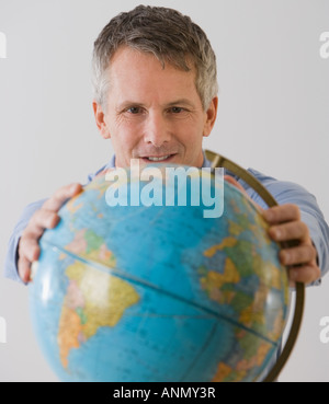 Man holding globe Stock Photo