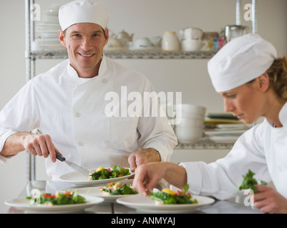 Male and female chefs plating food Stock Photo