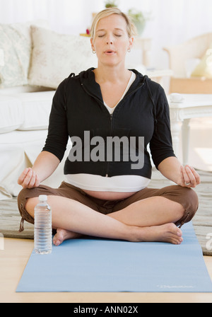 Pregnant woman meditating Stock Photo