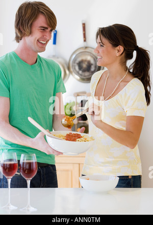 Couple preparing food in kitchen Stock Photo