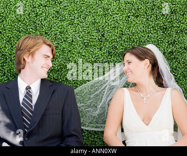 Bride and groom laying in grass Stock Photo