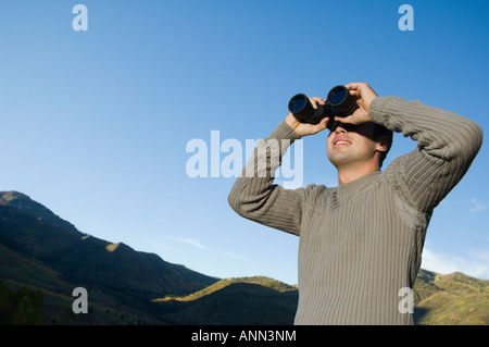 Man looking through binoculars, Utah, United States Stock Photo
