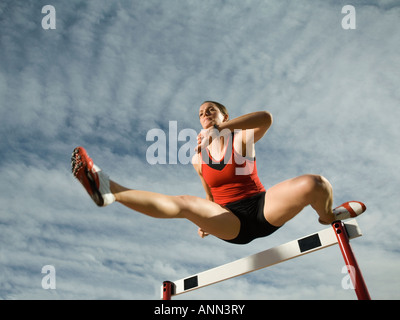 Female athlete jumping hurdle, Utah, United States Stock Photo