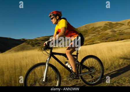 Woman riding mountain bike, Salt Flats, Utah, United States Stock Photo