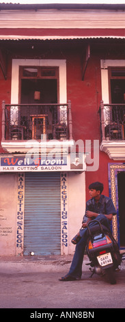 Indian man sitting on motorbike, Goa, India Stock Photo