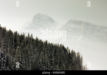 Lifting fog over mountain ranges around Lake Minnewonka, Banff National Park, Alberta, Canada Stock Photo