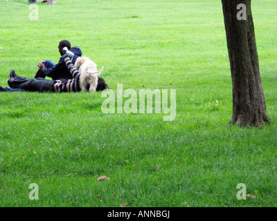 Couple and dog lying in Regent's Park, London Stock Photo