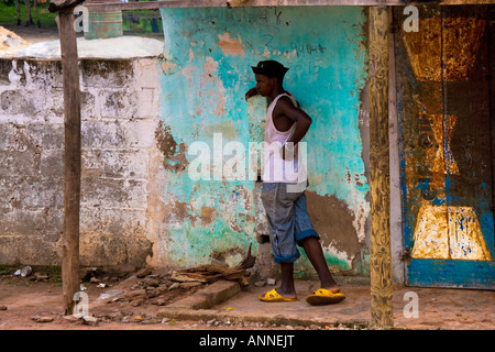 Candid photo of Gambian man leaning against a wall. Stock Photo