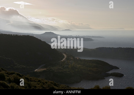 Looking south down the Messinian coast of the outer Mani on a misty morning from between Kardamyli and Stoupa Stock Photo