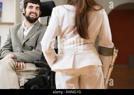 Portrait of a handicapped man and woman conversing. Stock Photo
