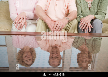 Friends sitting on couch Stock Photo