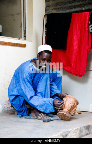 Wood carver at Senegambia Craft Market in the Kololi resort district of the Gambia, west Africa Stock Photo