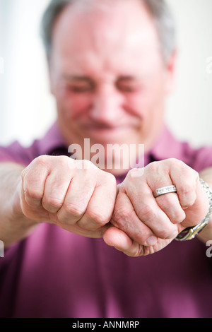 View of a mature man holding hands to be tied. Stock Photo
