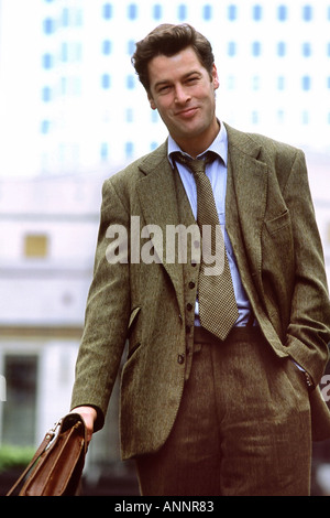 Business executive with briefcase smiling. Tony Rusecki Stock Photo