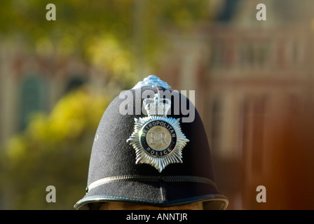 Horizontal close up of a policeman s iconic custodian helmet whilst on duty on the streets of London in the sunshine. Stock Photo
