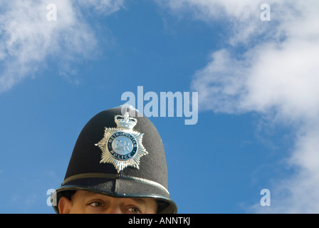 Horizontal close up of a policeman's iconic custodian helmet against a bright blue sky Stock Photo