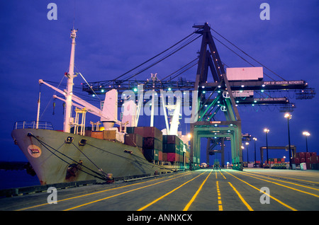 A docked cargo ship and loading cranes Stock Photo