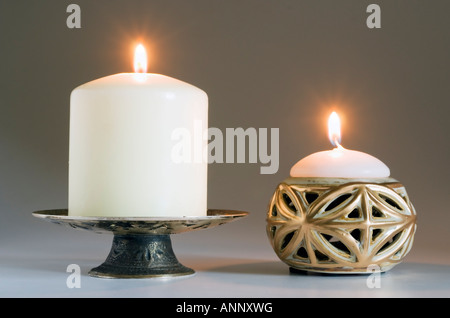 Two lit candles with holders Stock Photo