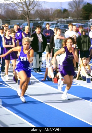 High school athletes competing at a track meet in Salt Lake City, Utah, USA. This is the women's 100 yard dash competition. Stock Photo