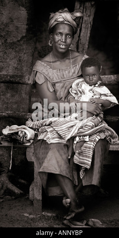 Sepia toned candid portrait of a Gambian African mother and baby.