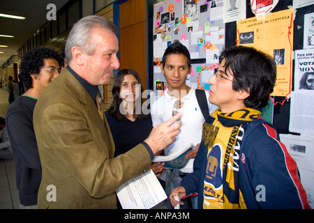 Professor speaking with students on the campus of the National Autonomous University of Mexico in Mexico City Mexico Stock Photo