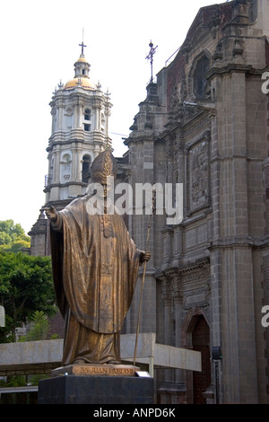 A brass statue of Pope John Paul II in front of the old Basilica of Guadalupe in Mexico City Mexico Stock Photo