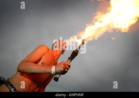 Circus performer doing stunts on a BMX and breathing fire Stock Photo