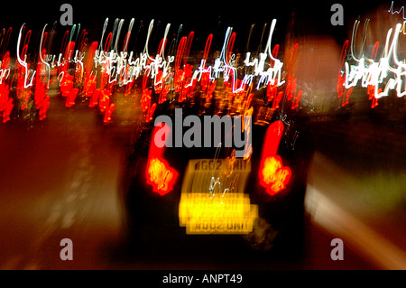 SHOT OF TRAFFIC ON MOTORWAY OR FREEWAY SHOWING STOPLIGHTS ON CAR WITH MOTION BLURRING Stock Photo