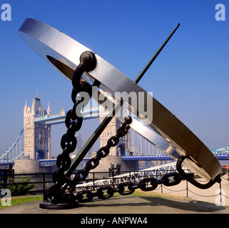 Tower Bridge with clock sundial in foreground from St Katherines Dock on a perfect blue sky sunny morning London UK Stock Photo