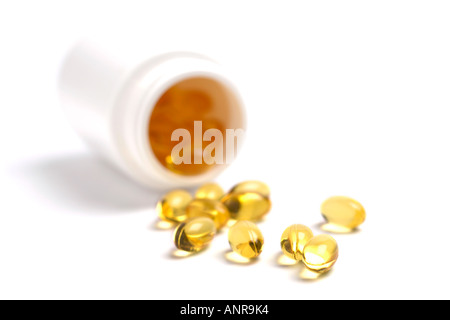 Cod Liver Oil capsules spilling from bottle Stock Photo