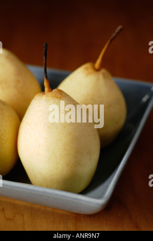Nashi Asian or Sand Pears in square ceramic bowl on wooden table Stock Photo