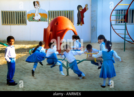 Abu Dhabi UAE Kindergarten Mixed Childrens Class On Roundabout Stock Photo