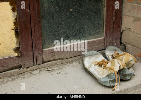 Discarded Shoes on a Windowsill Stock Photo