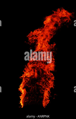 A column of bright fire against the night sky. Stock Photo