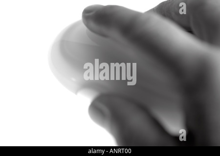 BLURRED MONO IMAGE OF A HAND USING A WIRELESS MOUSE Stock Photo