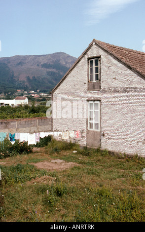 A house faced with scallop shells for protection from the elements near Ribeira in Galicia Spain Stock Photo