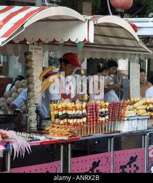 Stall selling fruit kebabs at chinese market Stock Photo