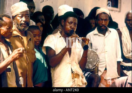 A musician playing a traditional ZUMARI or Swahili oboe at a wedding in Witu a small village on the coast of Kenya East Africa Stock Photo