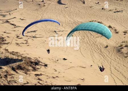 paragliders flying over dunes at Dune de Pyla France Stock Photo