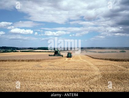 Harvesting a field of wheat in the Lincolnshire Wolds on the outskirts of the town of Louth Stock Photo