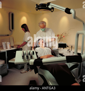 Dental Surgery with dentist, dental nurse and patient Stock Photo