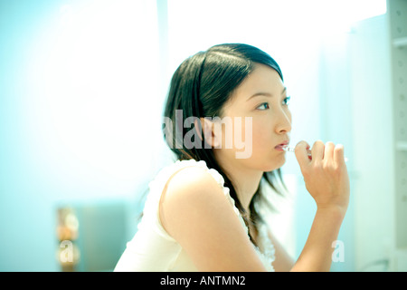 Young woman brushing teeth Stock Photo