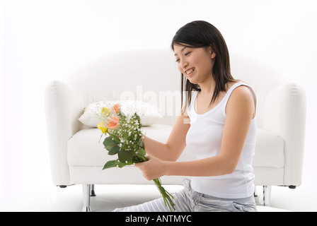 Young woman holding flowers Stock Photo
