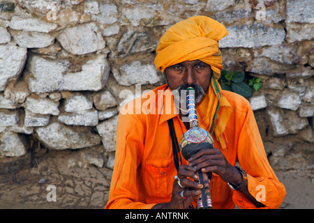 An Indian snake charmer playing flute Stock Photo