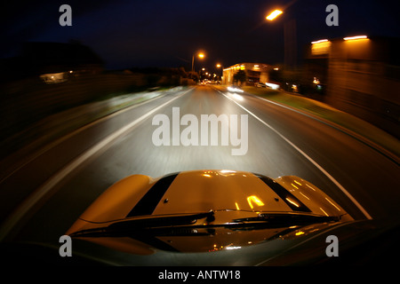 mini cooper convertible soft top driving at night Stock Photo