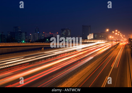 China Beijing car light trails and modern architecture on a city ring road Stock Photo