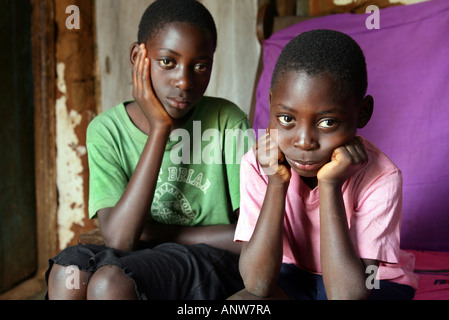 HIV/AIDS orphans in a village in Tanzania ho have lost her mother looking sadly into the camera. Stock Photo