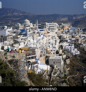 Clifftop view of white clustered buildings of Fira town with domed roof of church Santorini The Greek Islands, Greece Stock Photo