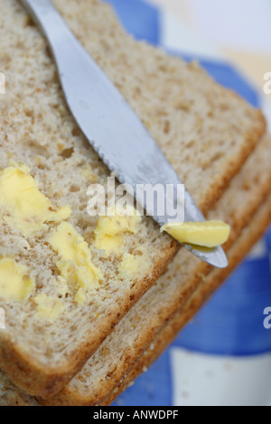 Wholemeal bread and butter with knife Stock Photo